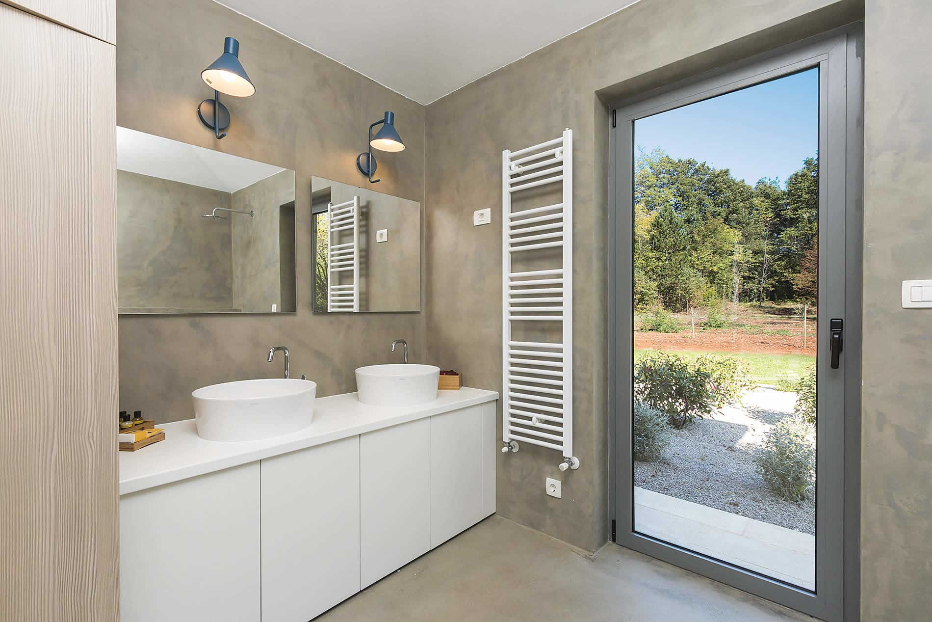 The master bathroom has its own access to the gardens and to the pool